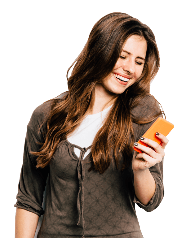 Happy female holding and looking at her phone smiling
